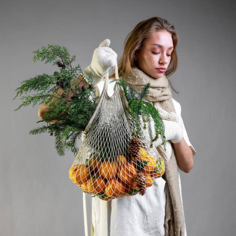 Авоська с мандаринами и ветками хвои